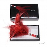 <strong>Красное перышко Tantra</strong> <br />
Хотите увидеть облик настоящего наслаждения? Он перед Вами! Легкость, воздушность, изысканность, соблазн, возбуждение, нежность прикосновения... Все это в перышке Tantra от LELO. Это самое невинное и простое орудие пробуждения страсти и доведения до экстаза. С одной стороны, это роскошные пуховые перья с ручкой из полированного металла и акрила, а с другой - это Ваша визитная карточка, стильное и многообещающее приглашение к фантастическим, умопомрачительным ласкам. Такое перышко просто обязано быть в Вашей коллекции! <div class="charTableblock"> </div> Красное перышко Tantra 
Хотите увидеть облик настоящего наслаждения? Он перед Вами! Легкость, воздушность, изысканность, соблазн, возбуждение, нежность прикосновения... Все это в перышке Tantra от LELO. Это самое невинное и простое орудие пробуждения страсти и доведения до экстаза. С одной стороны, это роскошные пуховые перья с ручкой из полированного металла и акрила, а с другой - это Ваша визитная карточка, стильное и многообещающее приглашение к фантастическим, умопомрачительным ласкам. Такое перышко просто обязано быть в Вашей коллекции!